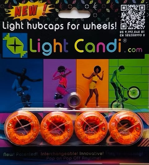 Packaged set of four Light Candi light hubcaps for wheels, featuring bright orange translucent hubcaps on a colorful retail backing card with the brand name and product description.