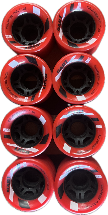 Eight red DART  roller skate derby wheels arranged in a 2x4 grid, showing their black inner hubs, black printed text, and black and white abstract shapes on a red background.